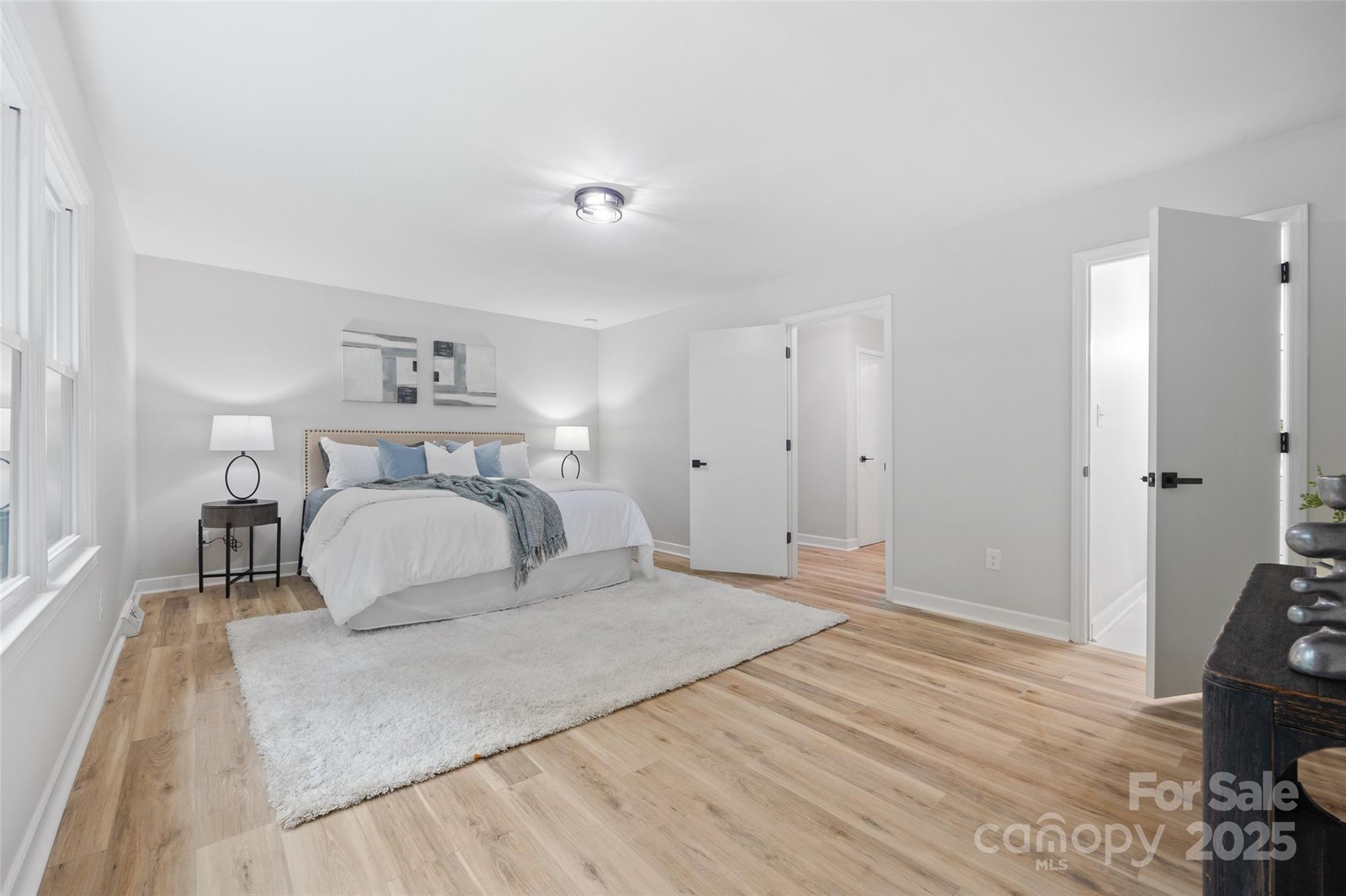 7301 Timber Ridge Drive Mint Hill, NC 28227 - Photo 16 of 37 a bedroom with a bed and wooden floor