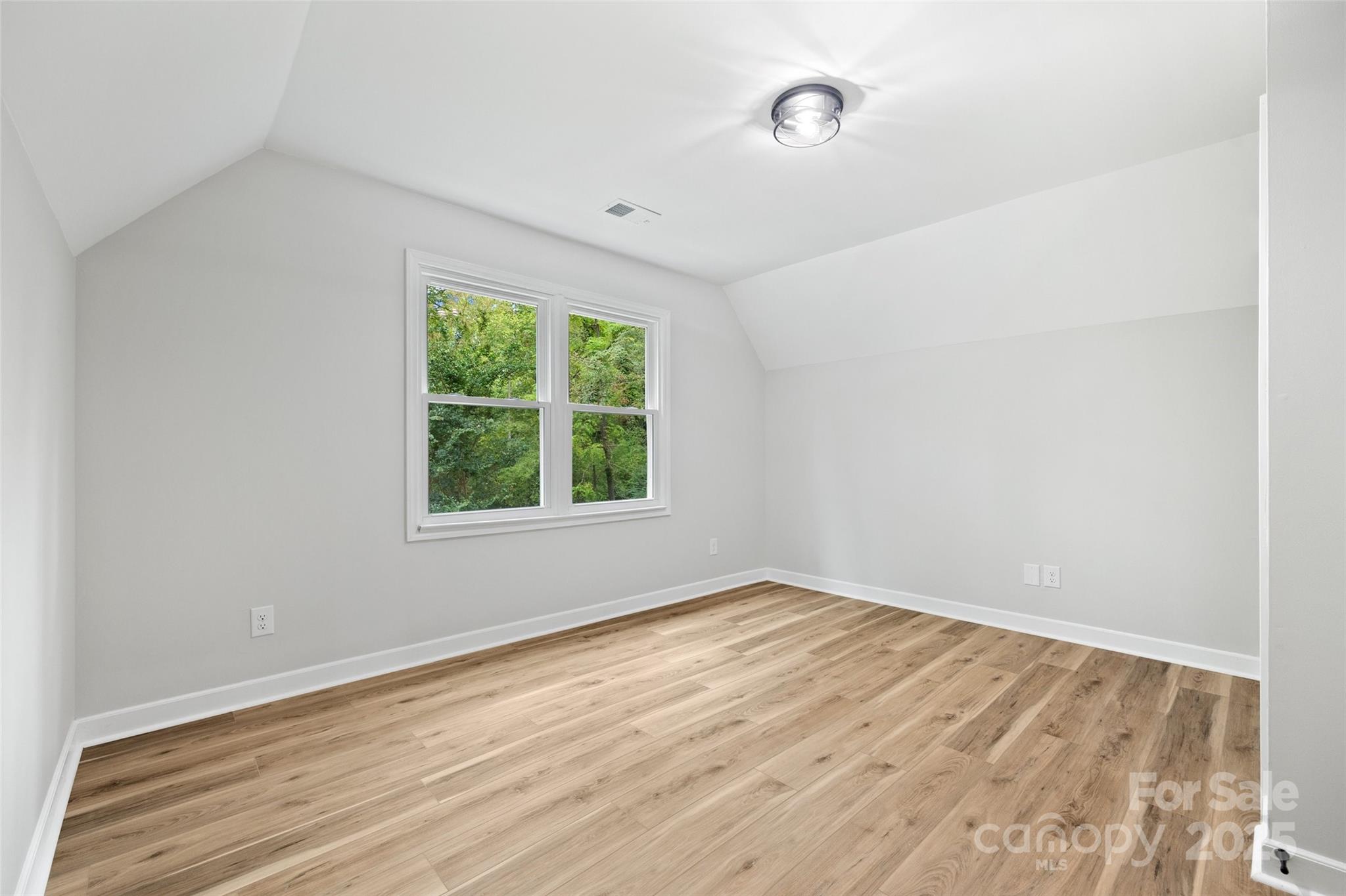 7301 Timber Ridge Drive Mint Hill, NC 28227 - Photo 23 of 37 a view of an empty room with wooden floor and a window