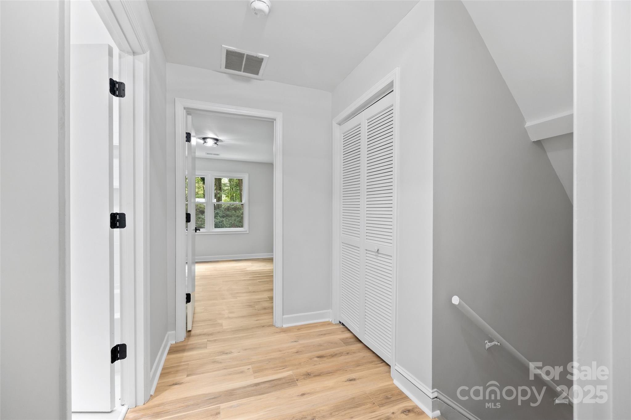 7301 Timber Ridge Drive Mint Hill, NC 28227 - Photo 24 of 37 a view of a hallway with wooden floor and staircase
