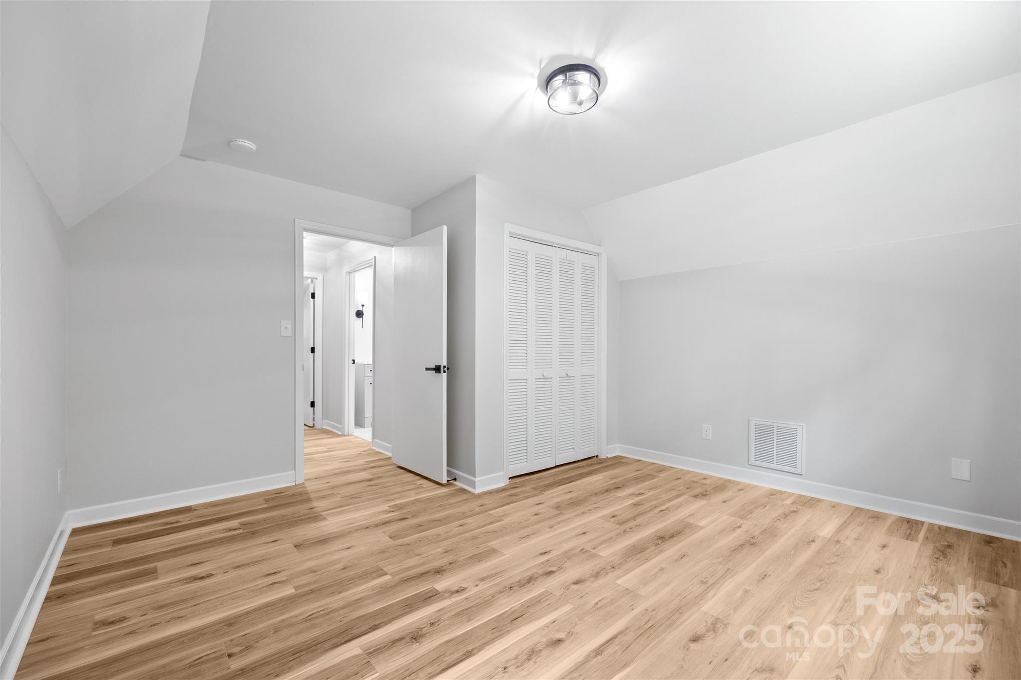 7301 Timber Ridge Drive Mint Hill, NC 28227 - Photo 25 of 37 a view of an empty room with wooden floor and a window