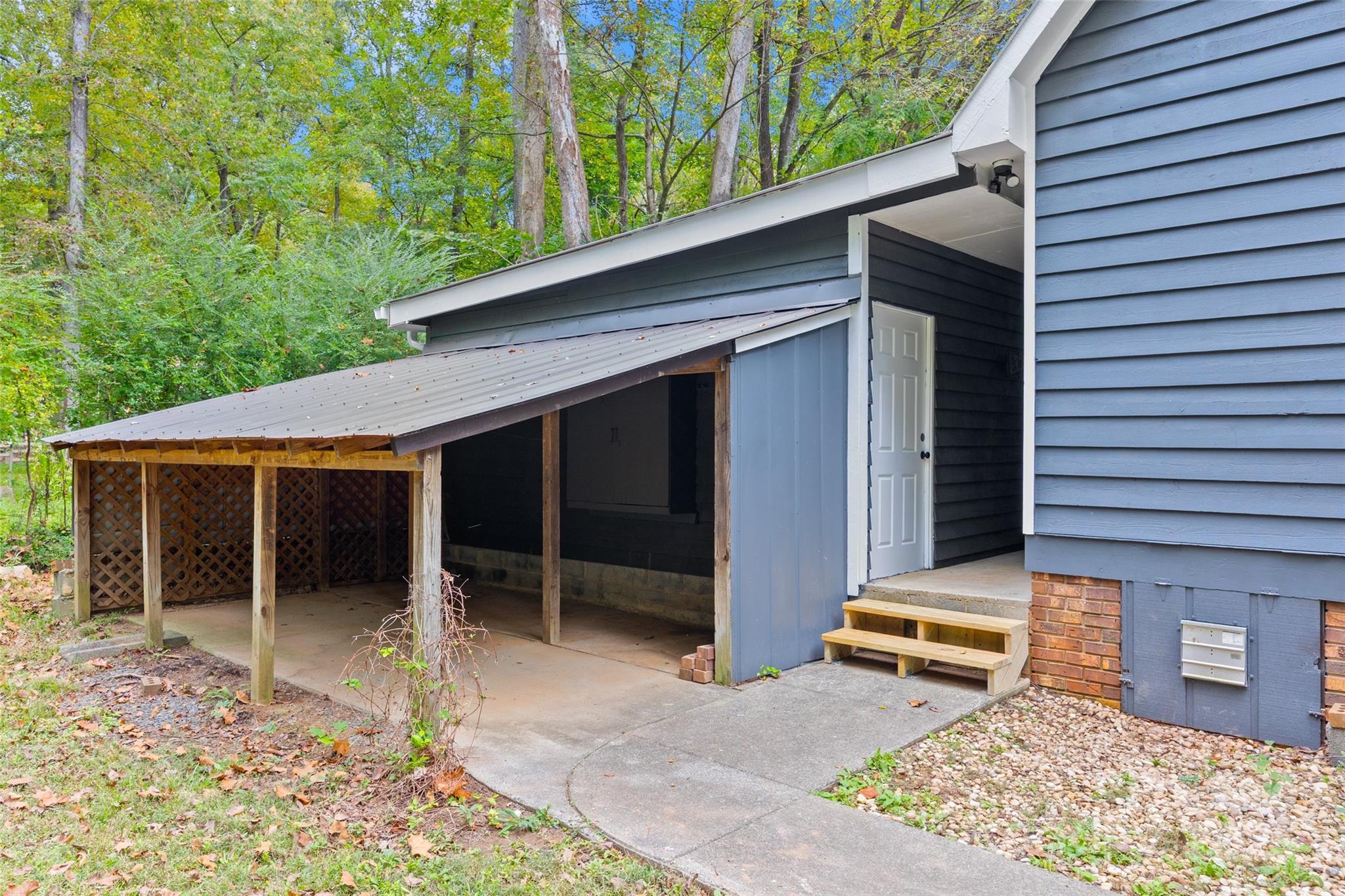 7301 Timber Ridge Drive Mint Hill, NC 28227 - Photo 26 of 37 a backyard of a house with barbeque oven table and chairs
