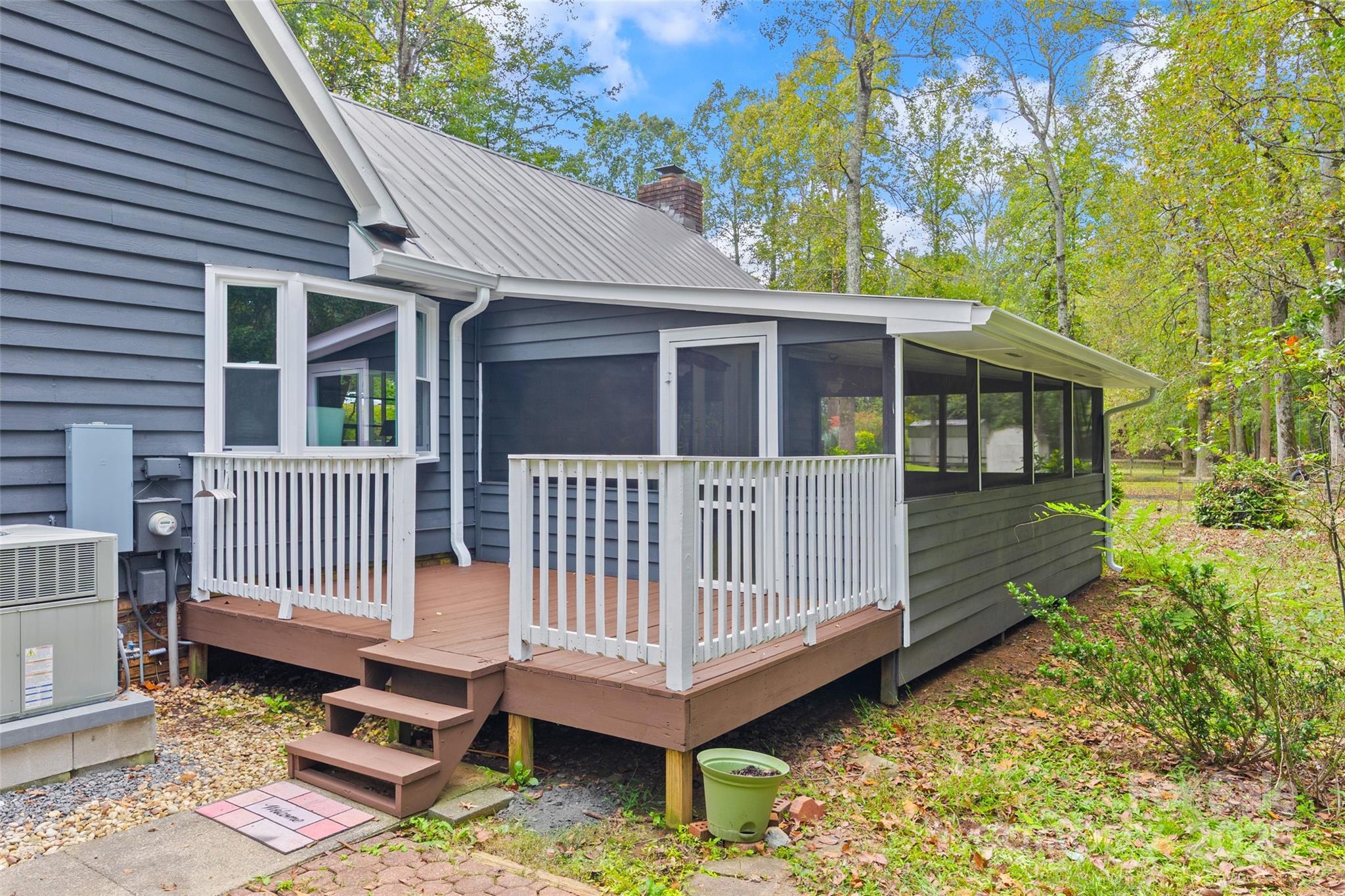 7301 Timber Ridge Drive Mint Hill, NC 28227 - Photo 30 of 37 a view of a house with a wooden deck and furniture