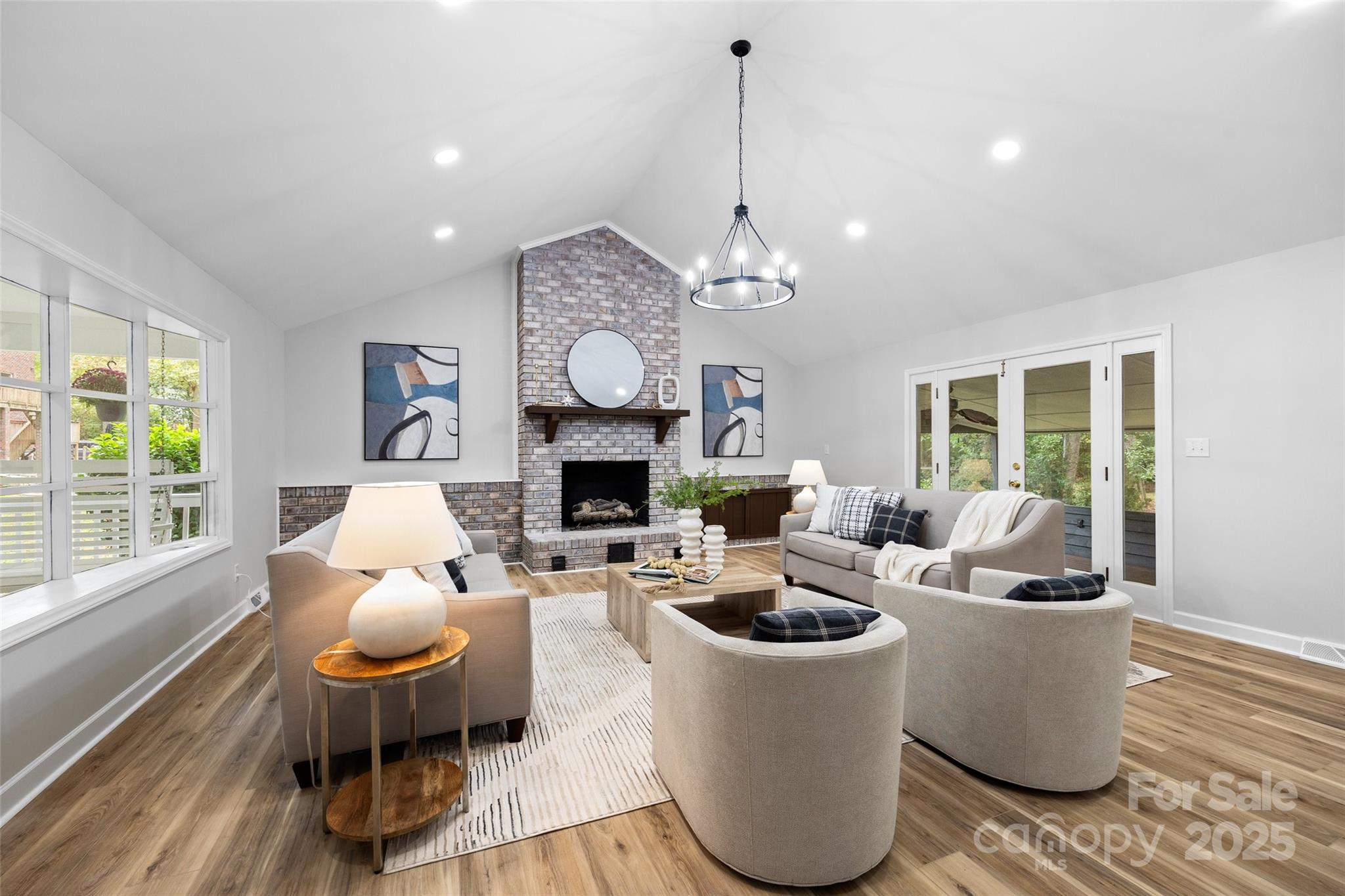 7301 Timber Ridge Drive Mint Hill, NC 28227 - Photo 7 of 37 a living room with fireplace furniture and a chandelier