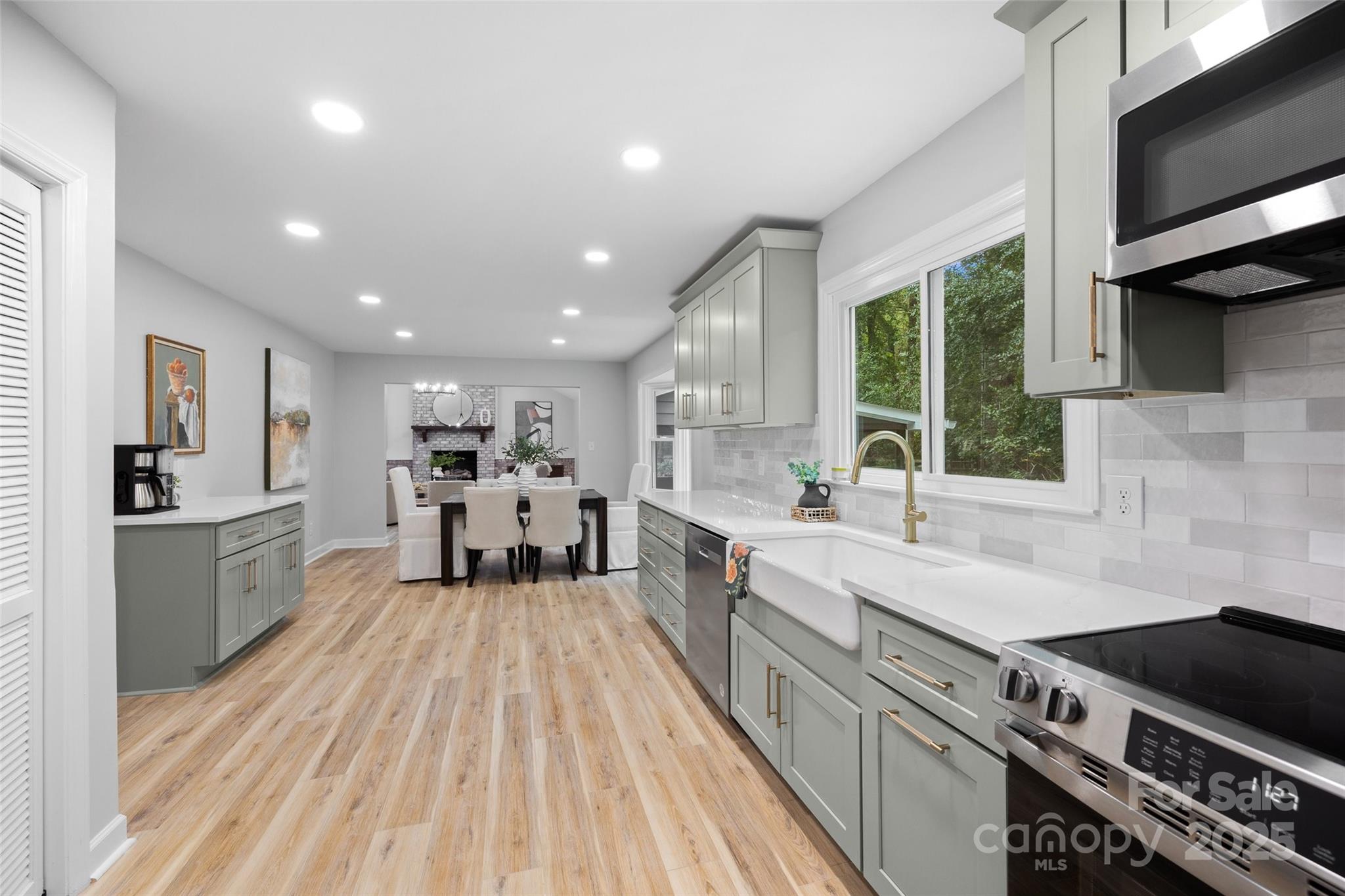 7301 Timber Ridge Drive Mint Hill, NC 28227 - Photo 8 of 37 a large kitchen with stainless steel appliances sink a stove and cabinets