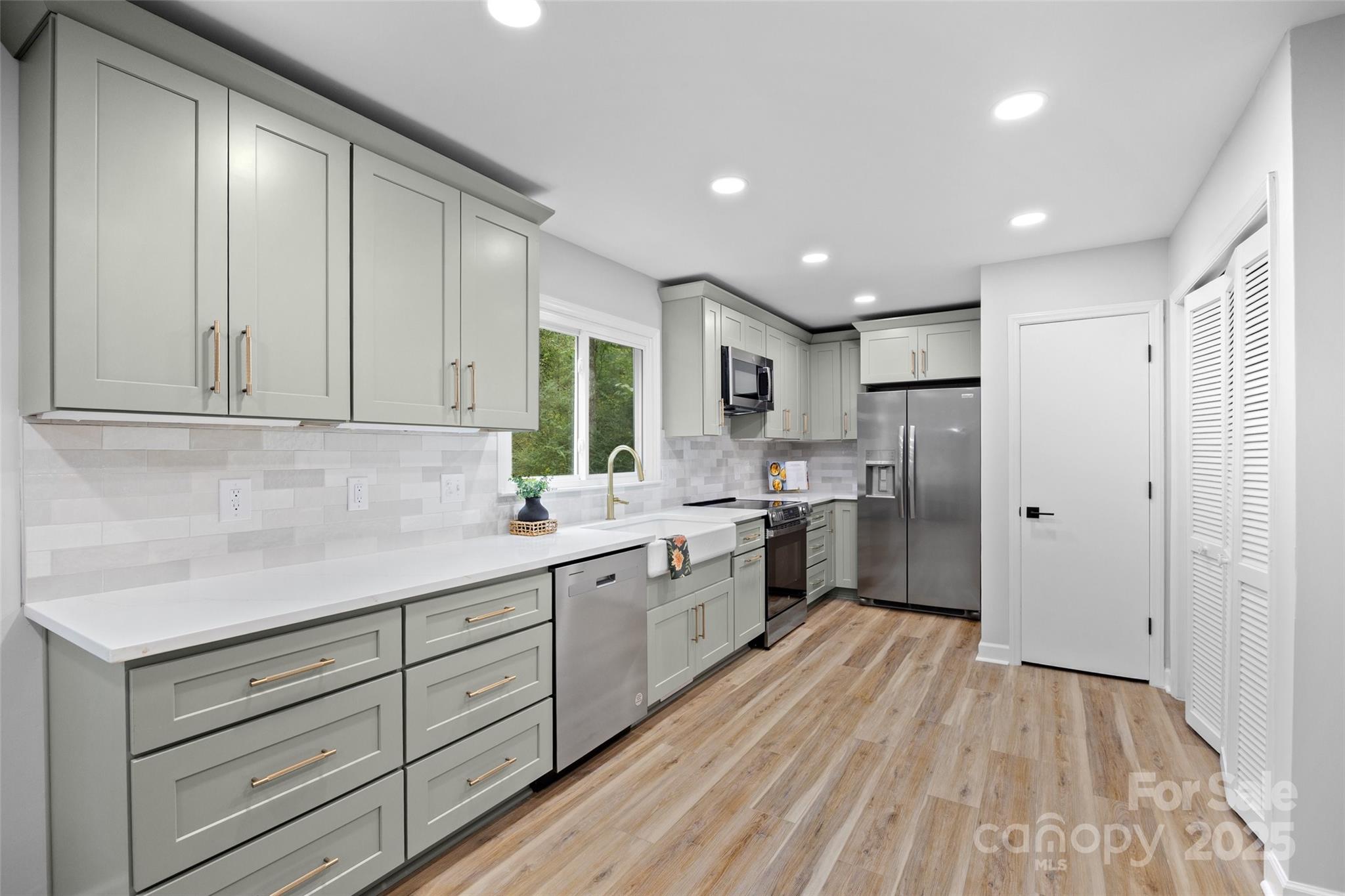 7301 Timber Ridge Drive Mint Hill, NC 28227 - Photo 10 of 37 a large kitchen with stainless steel appliances granite countertop a lot of counter space and wooden floors