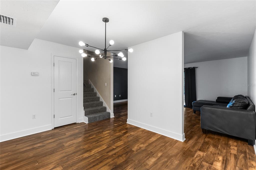 507 Northwest 39th Road, Unit 320 Gainesville, FL 32607 - Photo 18 of 33 a view of a livingroom with wooden floor and staircase