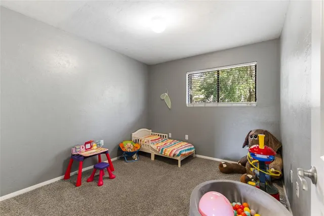 a bedroom with toys and a wooden floor