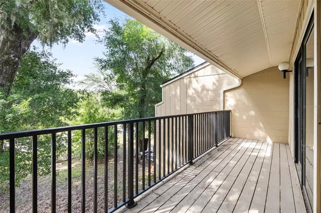 a view of balcony with wooden floor