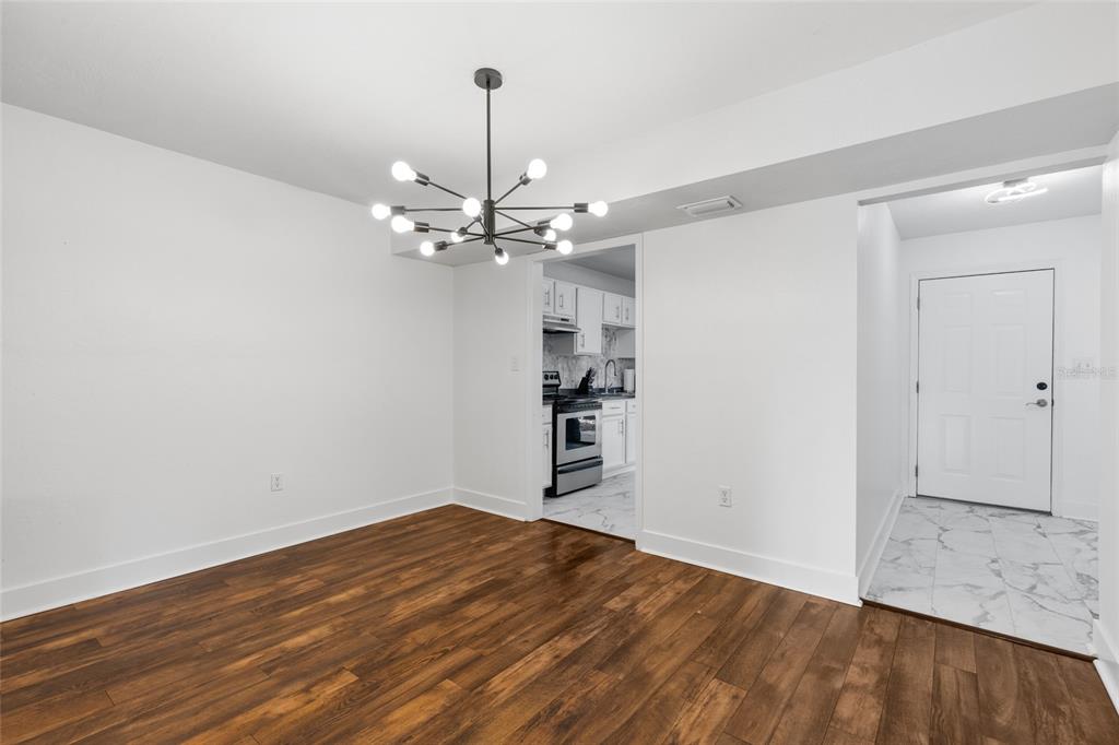 507 Northwest 39th Road, Unit 320 Gainesville, FL 32607 - Photo 8 of 33 a view of a room with wooden floor and closet