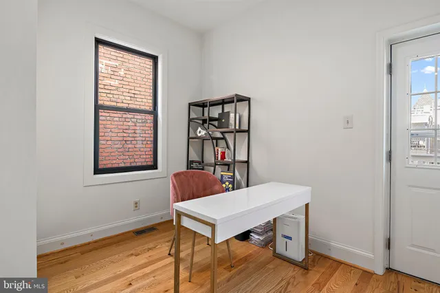 a view of a room that has a window and a table in it