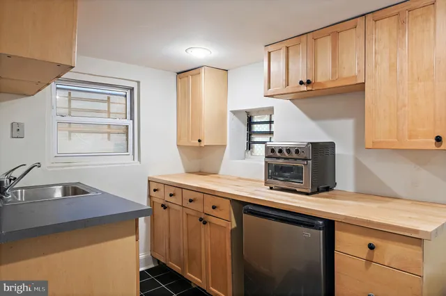 a kitchen with stainless steel appliances a stove a sink and a microwave