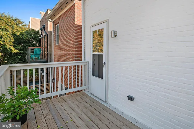 a view of a balcony with wooden floor and fence