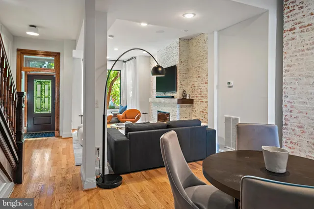 a living room with furniture fireplace and a flat screen tv