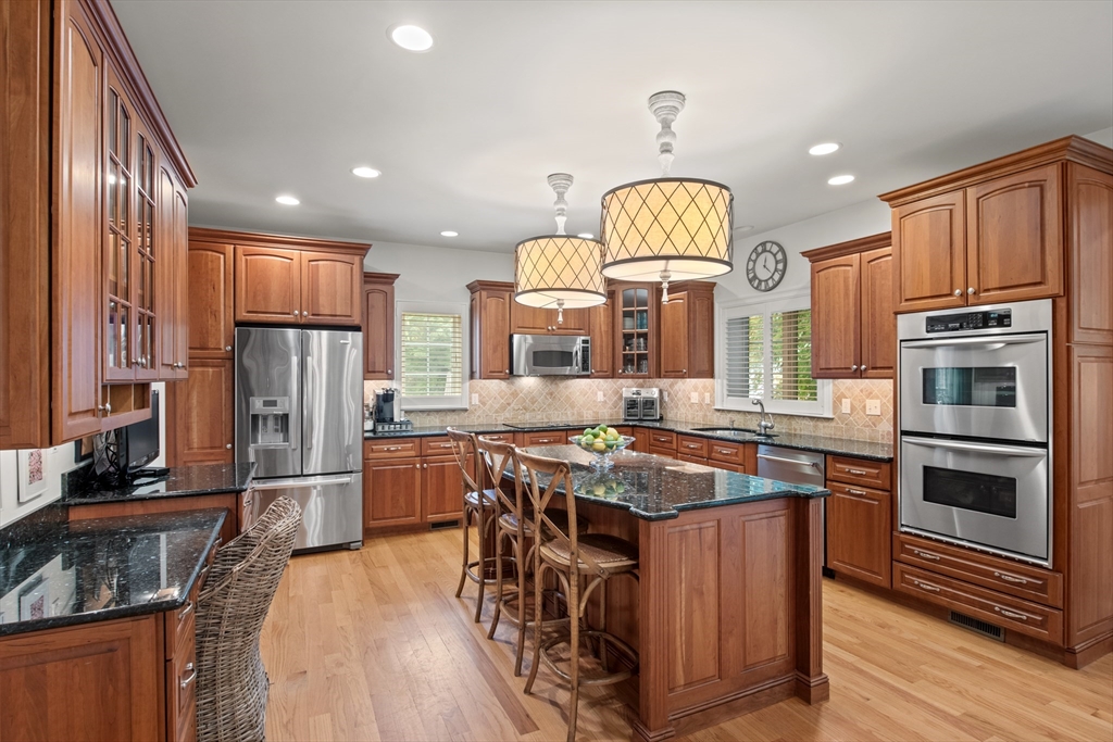 38 Longacre Road Needham, MA 02492 - Photo 22 of 42 a kitchen with stainless steel appliances granite countertop a stove refrigerator and microwave