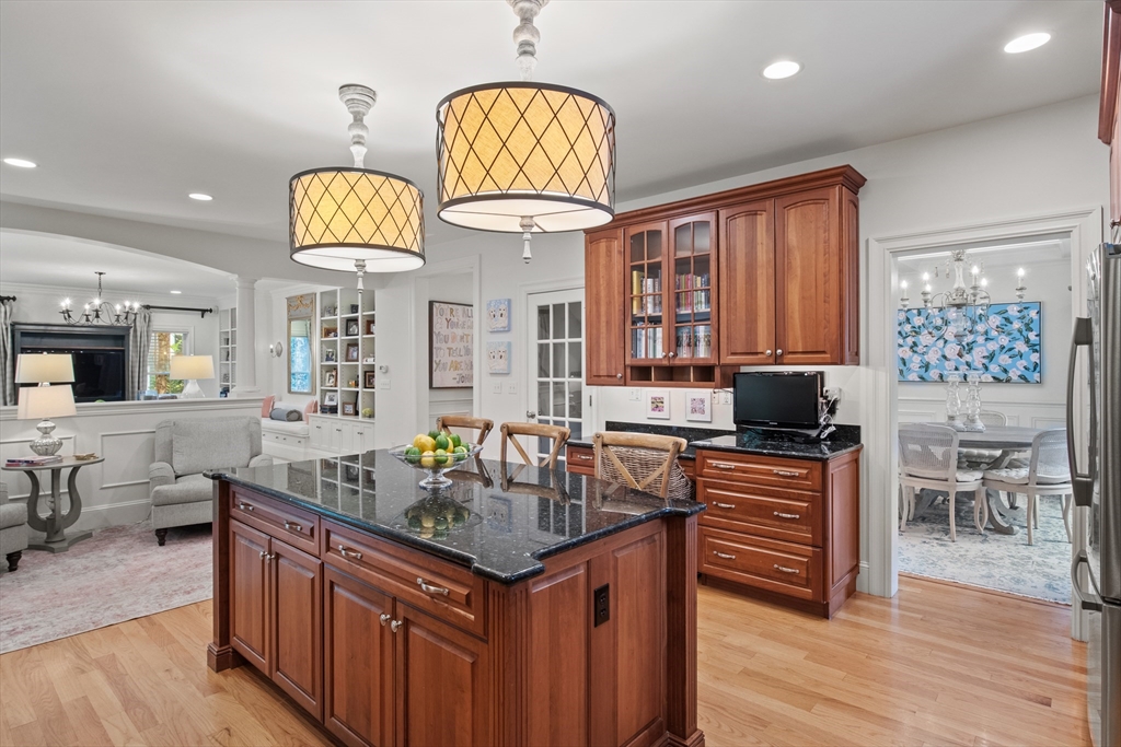 38 Longacre Road Needham, MA 02492 - Photo 23 of 42 a kitchen with stainless steel appliances granite countertop a stove a sink dishwasher and a dining table with wooden floor