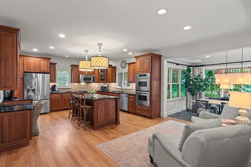 38 Longacre Road Needham, MA 02492 - Photo 24 of 42 a large living room with stainless steel appliances granite countertop a couch wooden floor and a large window