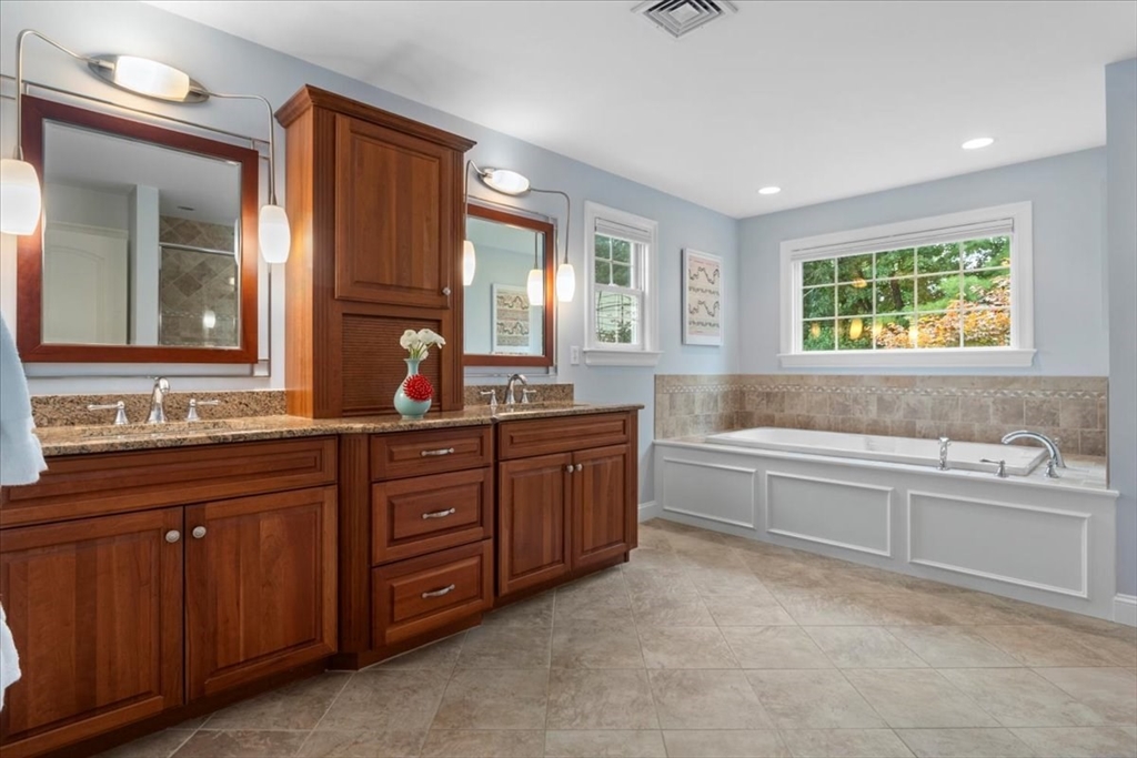 38 Longacre Road Needham, MA 02492 - Photo 28 of 42 a bathroom with a granite countertop double vanity sink a mirror and a bathtub