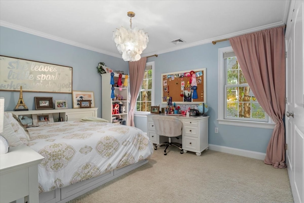 38 Longacre Road Needham, MA 02492 - Photo 33 of 42 a bedroom with a bed and a chandelier