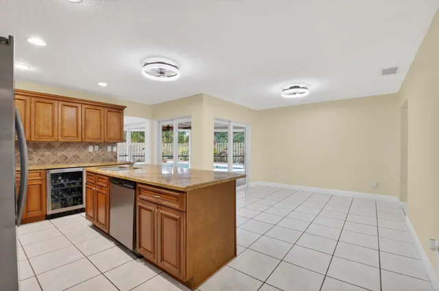 a kitchen with stainless steel appliances granite countertop a stove and a sink