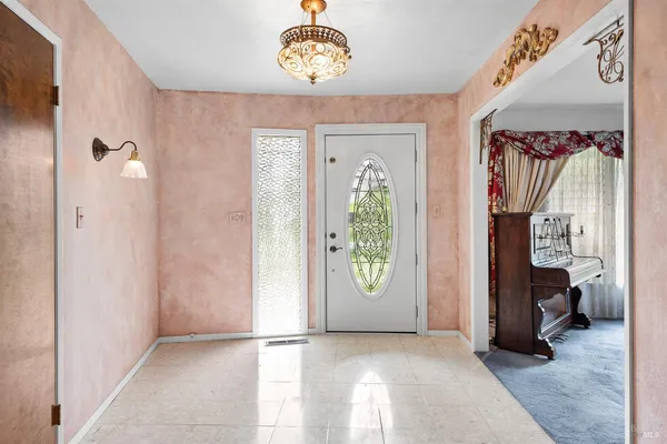 a view of a hallway with entryway door front door