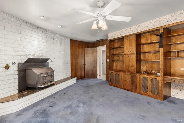 a bathroom with a granite countertop sink a mirror and a shower