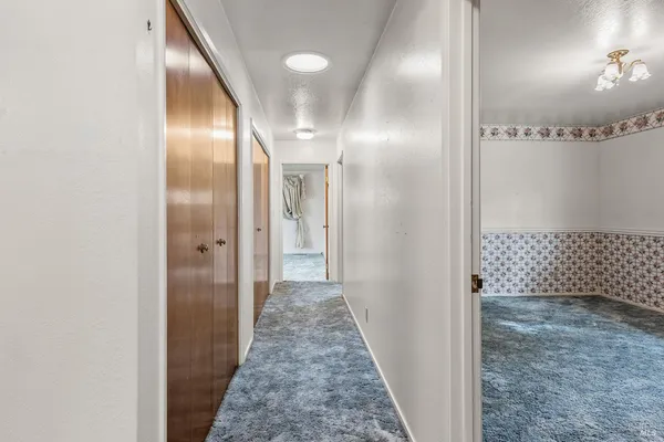 a bathroom with a sink a light fixture and a mirror