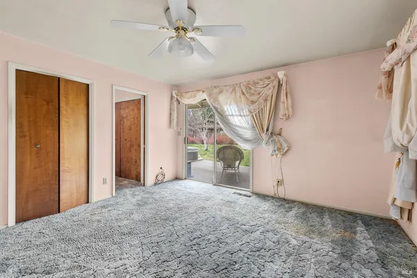 a bedroom with a large bed and a window