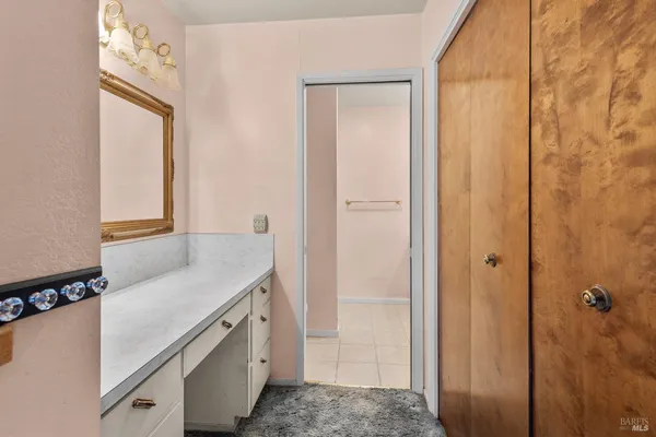 a bathroom with a sink vanity and mirror