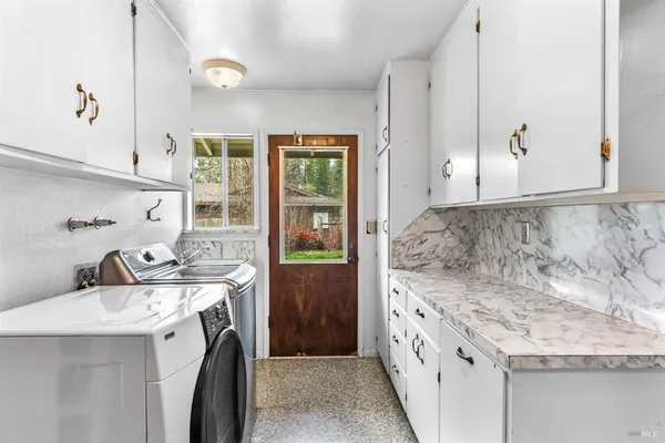 a bathroom with a granite countertop sink a mirror and a shower