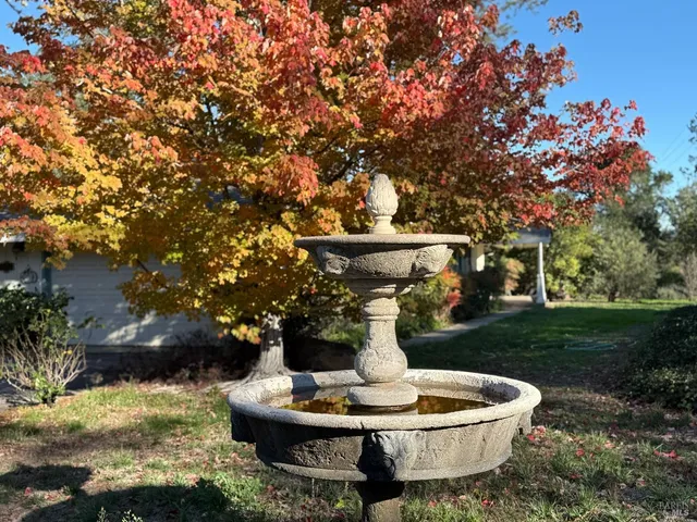a front view of a house with a yard table and chairs