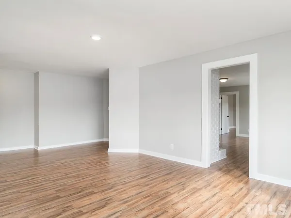 a view of wooden floor and windows in a room