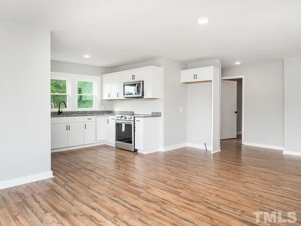 a view of kitchen with granite countertop cabinets and wooden floor