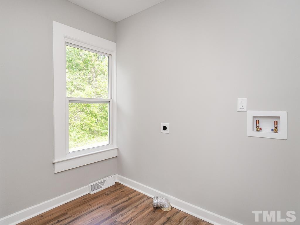 1235 South Main Street Graham, NC 27253 - Photo 16 of 33 an empty room with wooden floor and a window