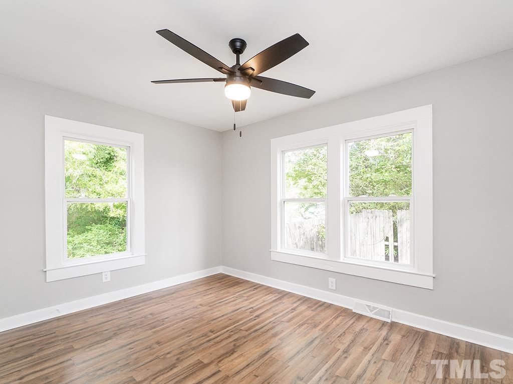 1235 South Main Street Graham, NC 27253 - Photo 20 of 33 a view of an empty room with wooden floor and a window