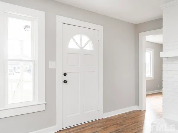 a view of front door with wooden floor
