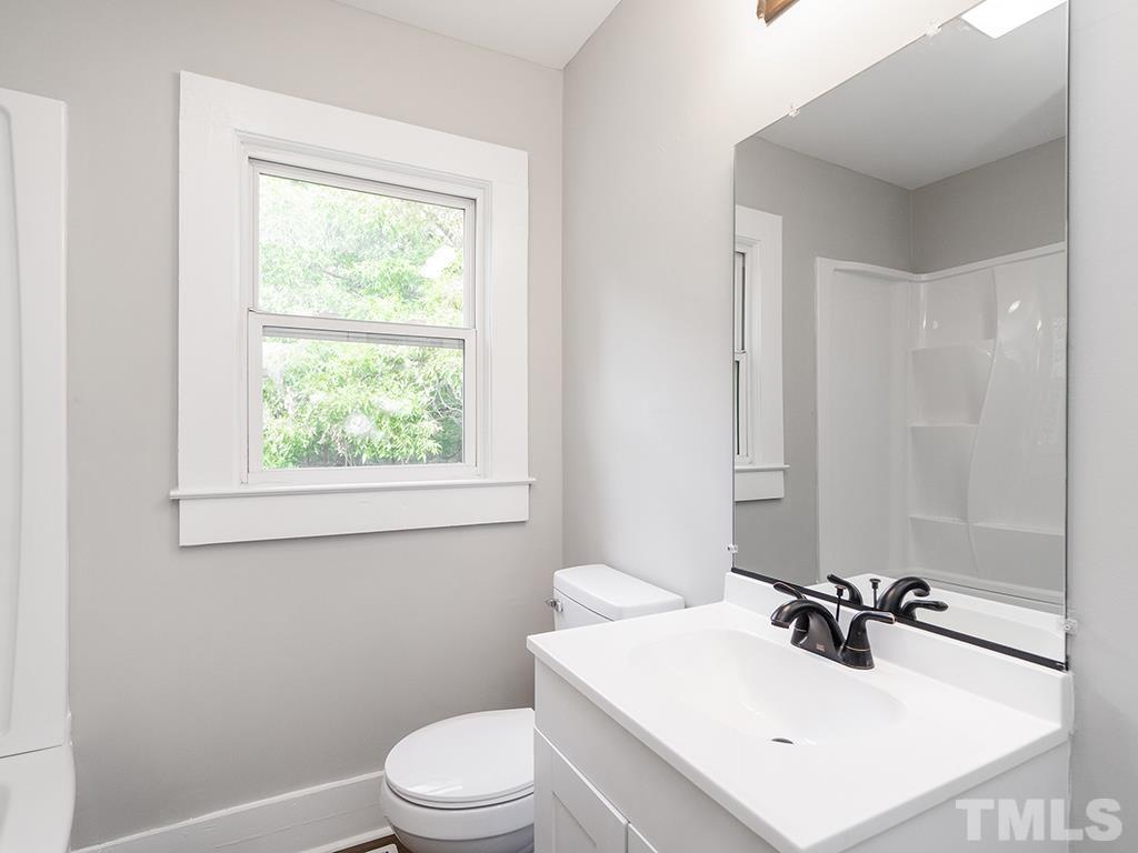 1235 South Main Street Graham, NC 27253 - Photo 21 of 33 a bathroom with a sink toilet vanity and mirror
