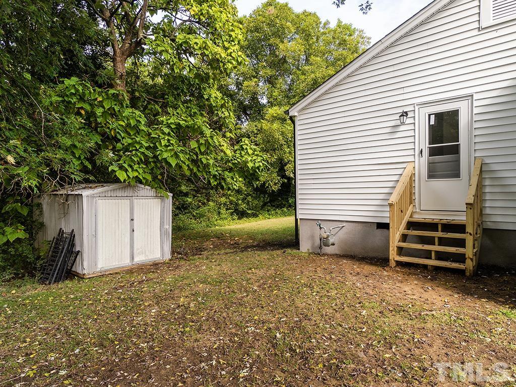 1235 South Main Street Graham, NC 27253 - Photo 25 of 33 a view of a house with a backyard and wooden fence