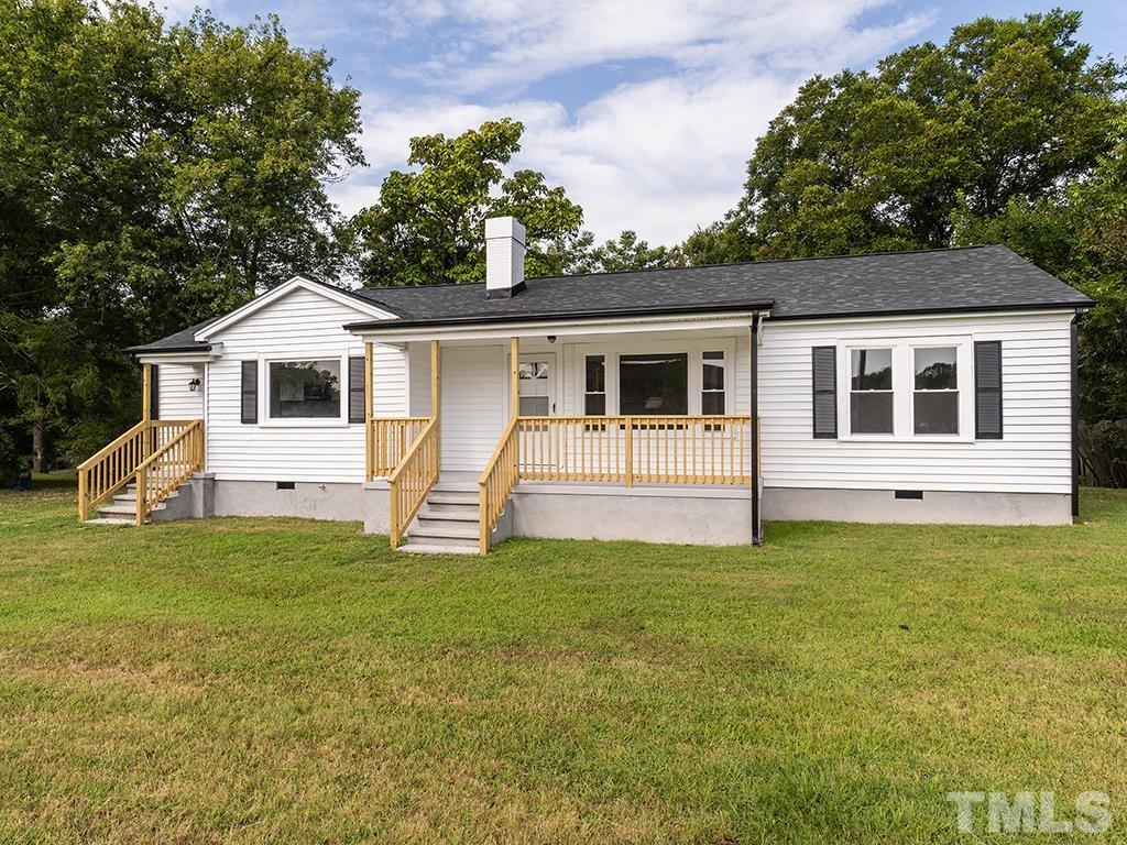 1235 South Main Street Graham, NC 27253 - Photo 28 of 33 a front view of a house with a garden and yard