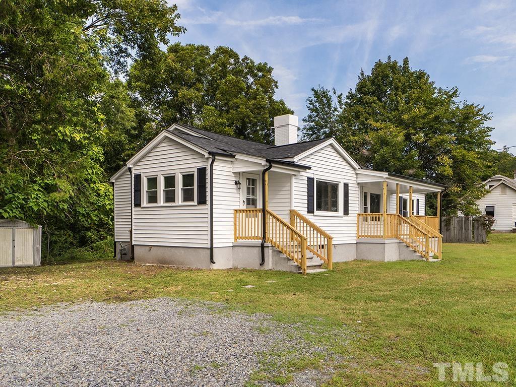 1235 South Main Street Graham, NC 27253 - Photo 29 of 33 a front view of a house with a garden and trees