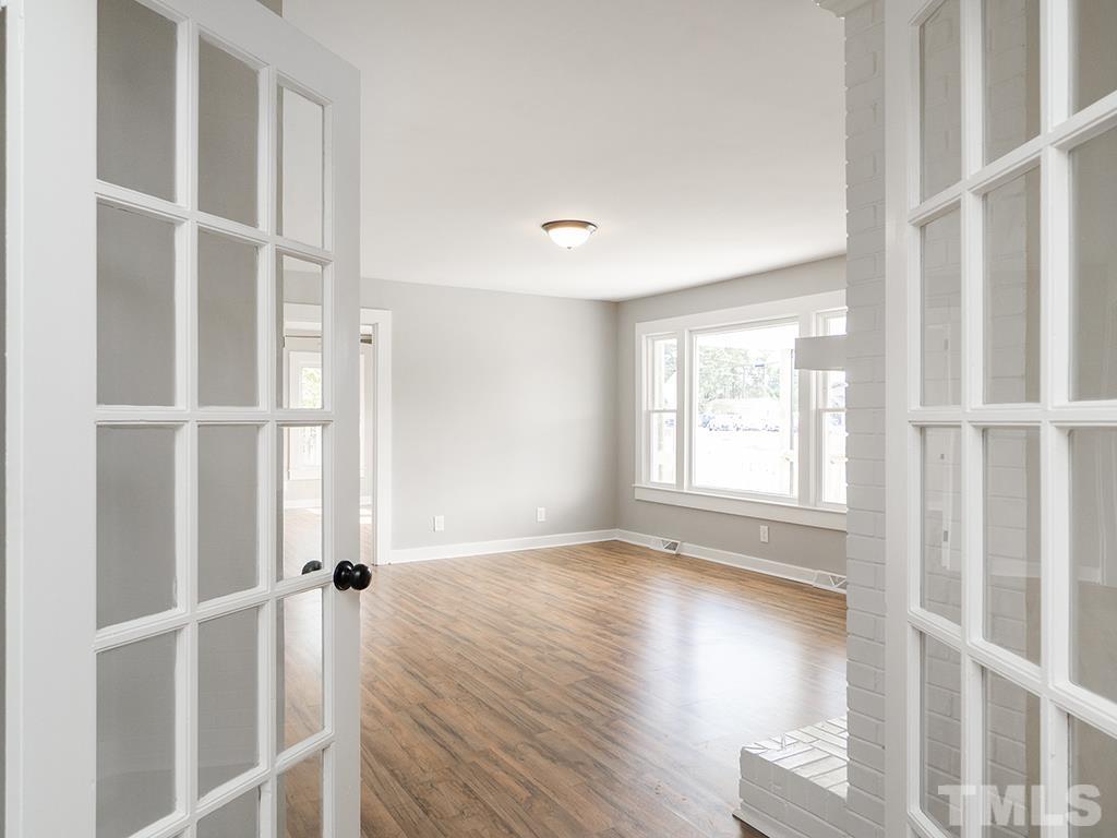 1235 South Main Street Graham, NC 27253 - Photo 30 of 33 a view of an empty room with wooden floor and a window