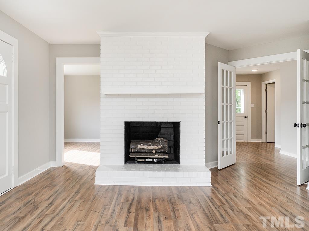 1235 South Main Street Graham, NC 27253 - Photo 31 of 33 a view of a livingroom with wooden floor and a fireplace