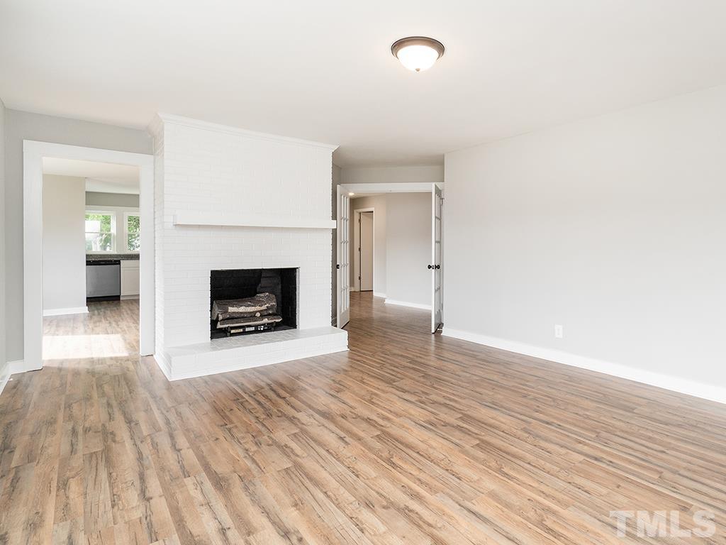 1235 South Main Street Graham, NC 27253 - Photo 32 of 33 a view of a livingroom with wooden floor and a fireplace