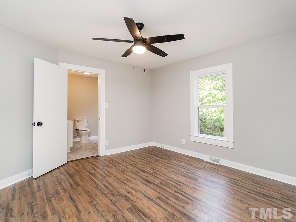 1235 South Main Street Graham, NC 27253 - Photo 4 of 33 a view of empty room with wooden floor and ceiling fan