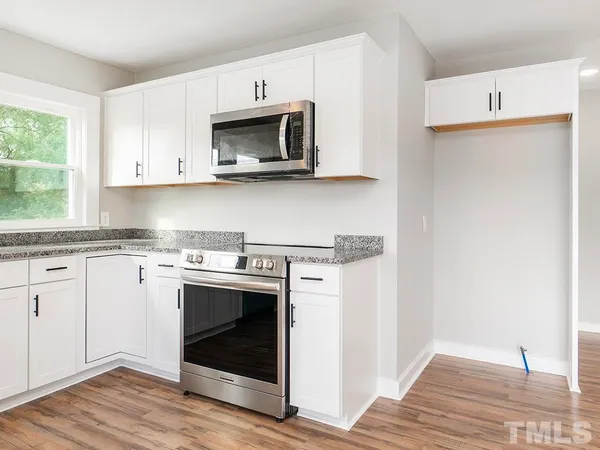 a kitchen with a stove and a microwave