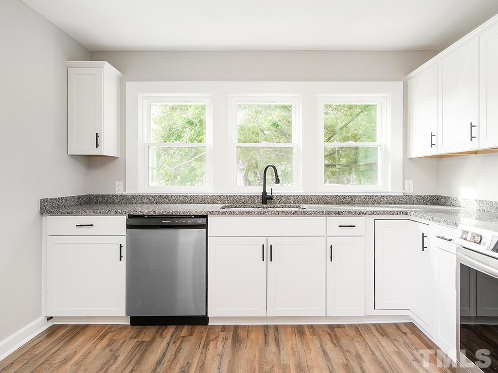 1235 South Main Street Graham, NC 27253 - Photo 7 of 33 a kitchen with granite countertop white cabinets and a window