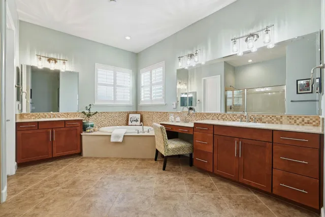 a large bathroom with a sink mirror and a bathtub
