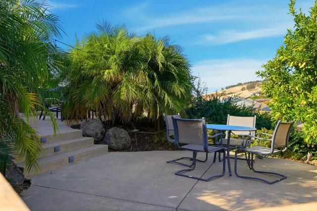 a view of a backyard with furniture
