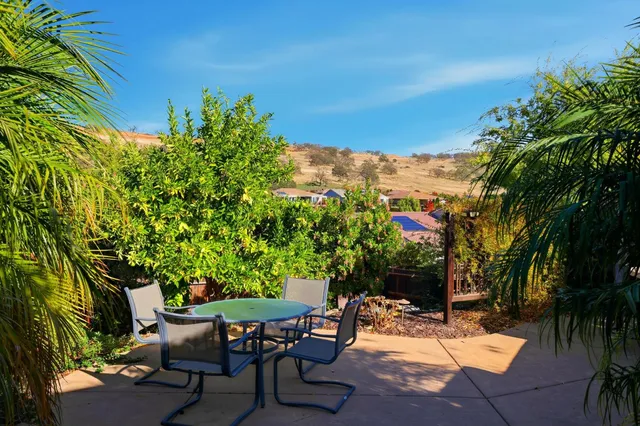 a view of a chairs and table in a patio