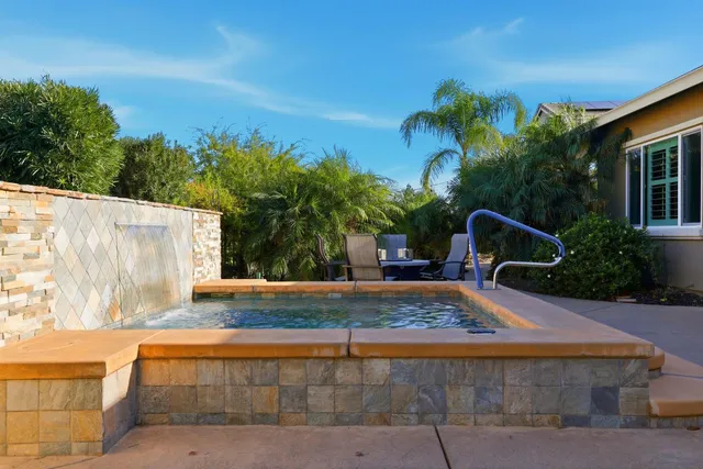 a view of a backyard with plants and outdoor seating