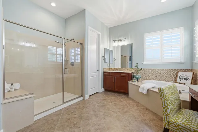 a bathroom with a tub sink toilet and shower